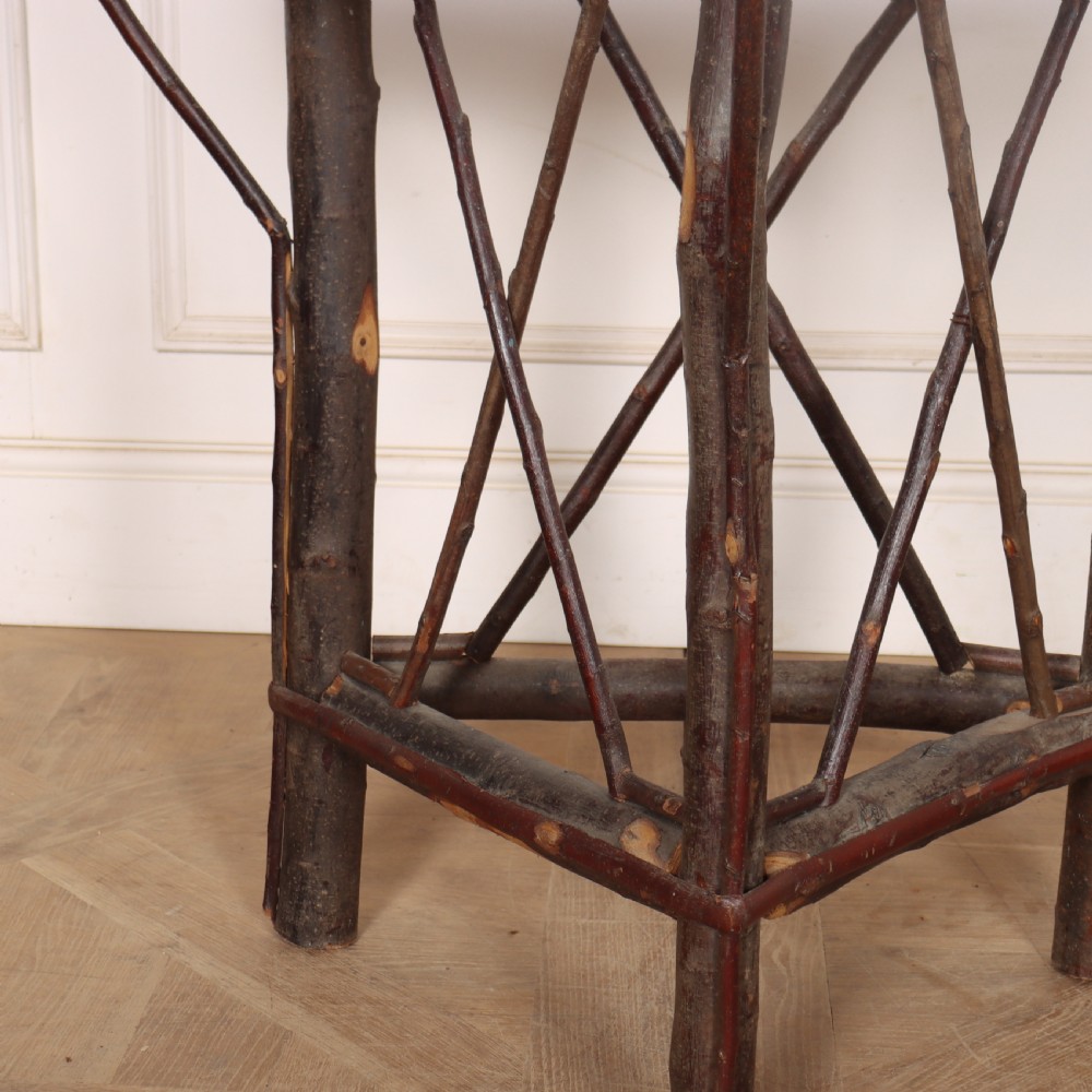 A demilune console table crafted from unpeeled rustic tree branches with a patterned teal painted top. View VI