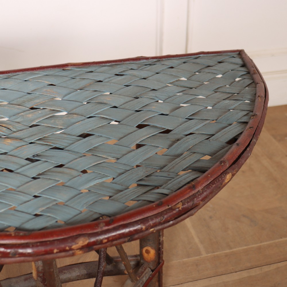 A demilune console table crafted from unpeeled rustic tree branches with a patterned teal painted top. View VII