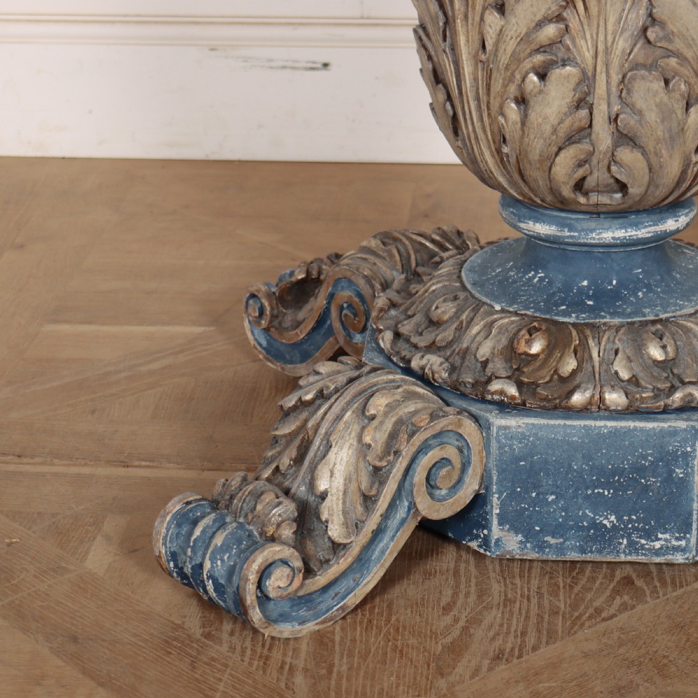 A circular 1920s German centre table featuring a distressed slate blue painted finish, gilt carved acanthus leaf pedestal, and scroll feet. View II