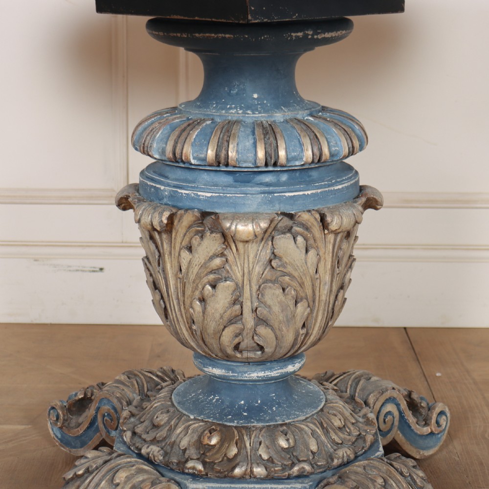 A circular 1920s German centre table featuring a distressed slate blue painted finish, gilt carved acanthus leaf pedestal, and scroll feet. View IV