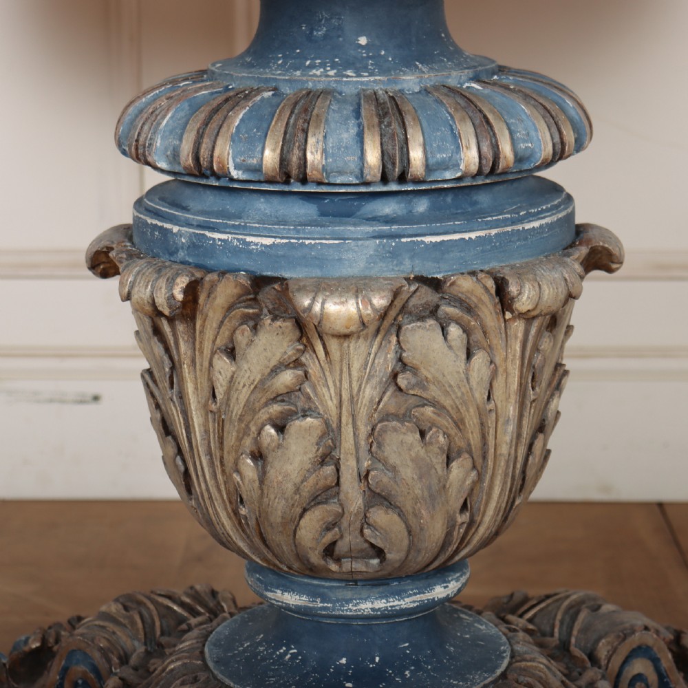 A circular 1920s German centre table featuring a distressed slate blue painted finish, gilt carved acanthus leaf pedestal, and scroll feet. View VI