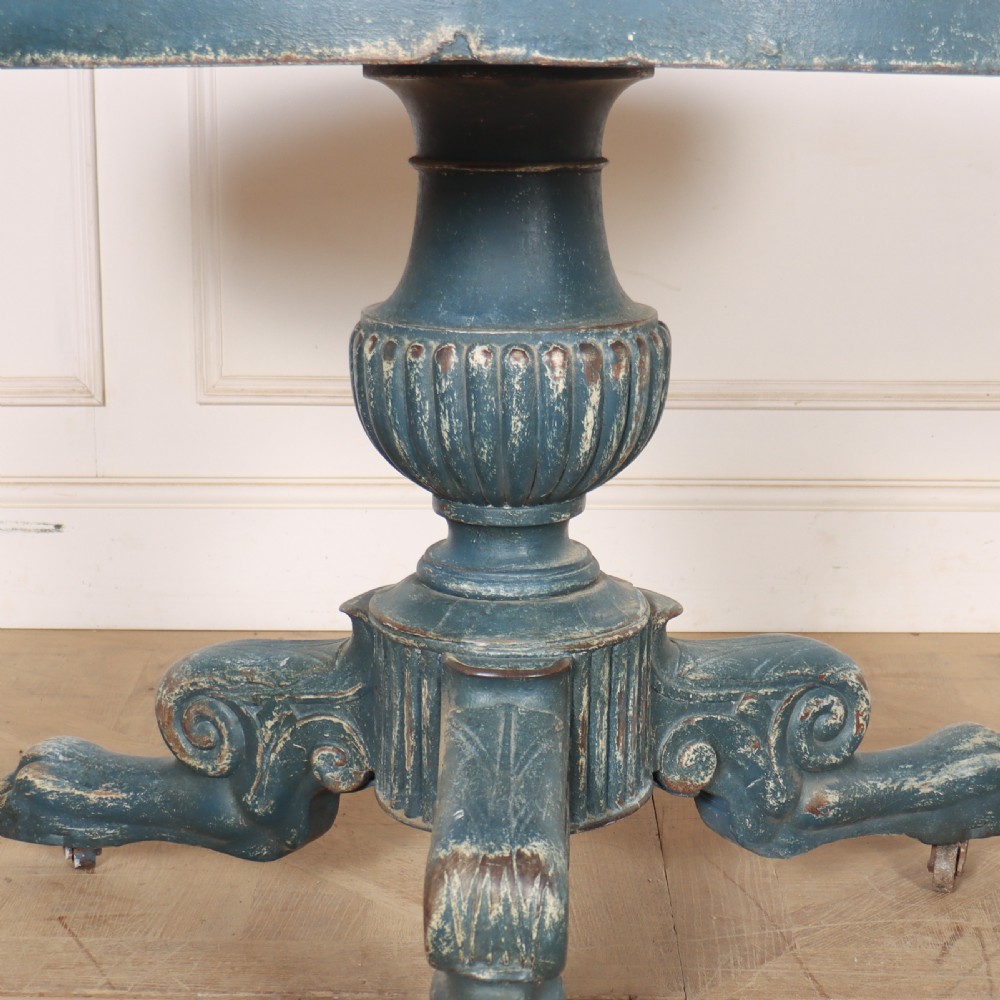 A circular French gueridon table featuring a grey marble top and a distressed blue painted pedestal base resting on carved scroll feet. View II