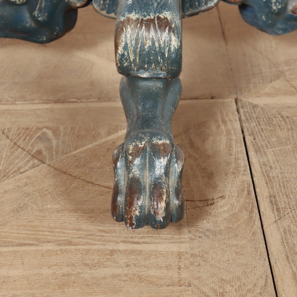 A circular French gueridon table featuring a grey marble top and a distressed blue painted pedestal base resting on carved scroll feet. View III