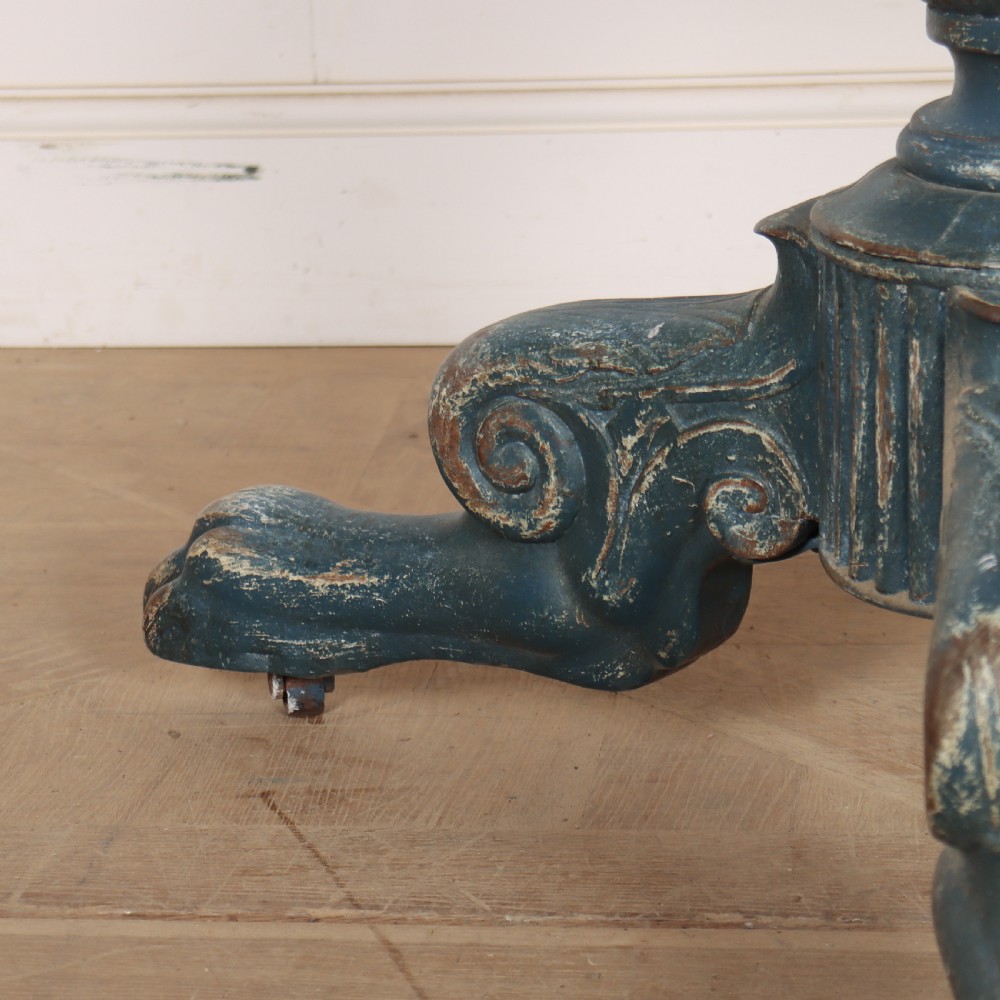A circular French gueridon table featuring a grey marble top and a distressed blue painted pedestal base resting on carved scroll feet. View V