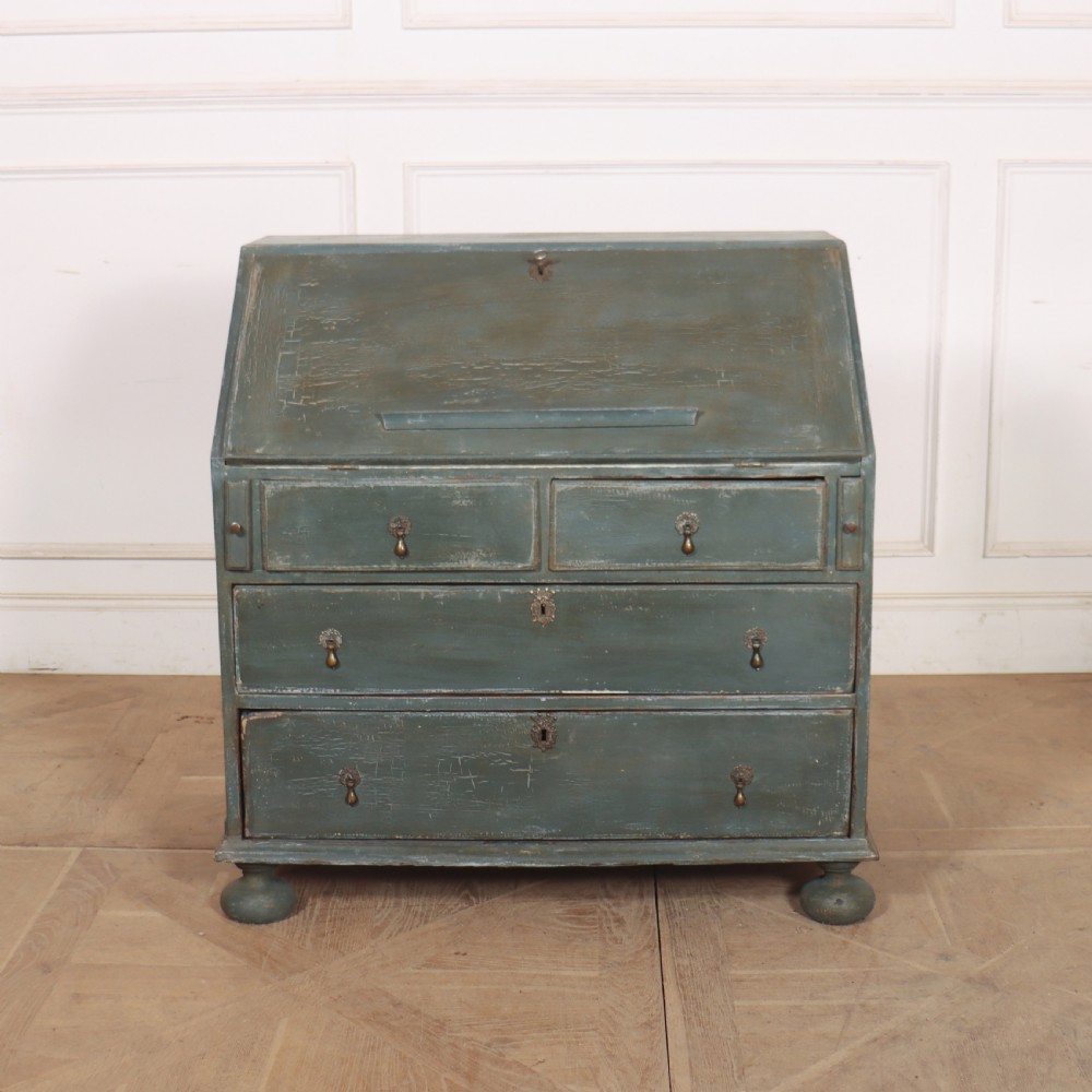 An 18th-century English slant-front bureau with a distressed grey-green painted finish, brass pull handles, and turned feet. View II