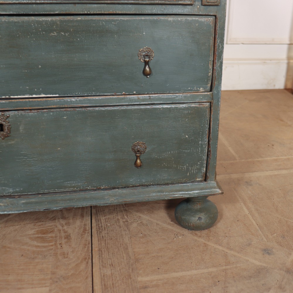 An 18th-century English slant-front bureau with a distressed grey-green painted finish, brass pull handles, and turned feet. View VIII