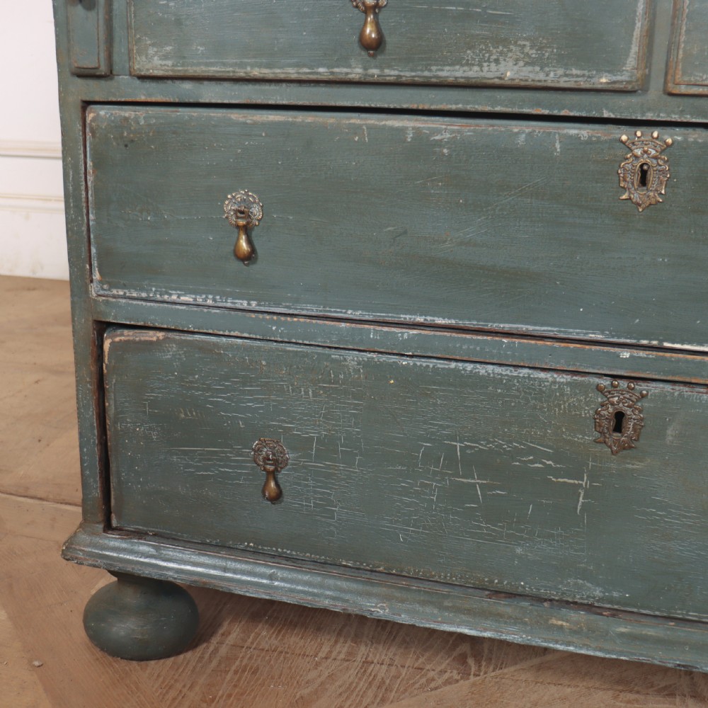 An 18th-century English slant-front bureau with a distressed grey-green painted finish, brass pull handles, and turned feet. View IX