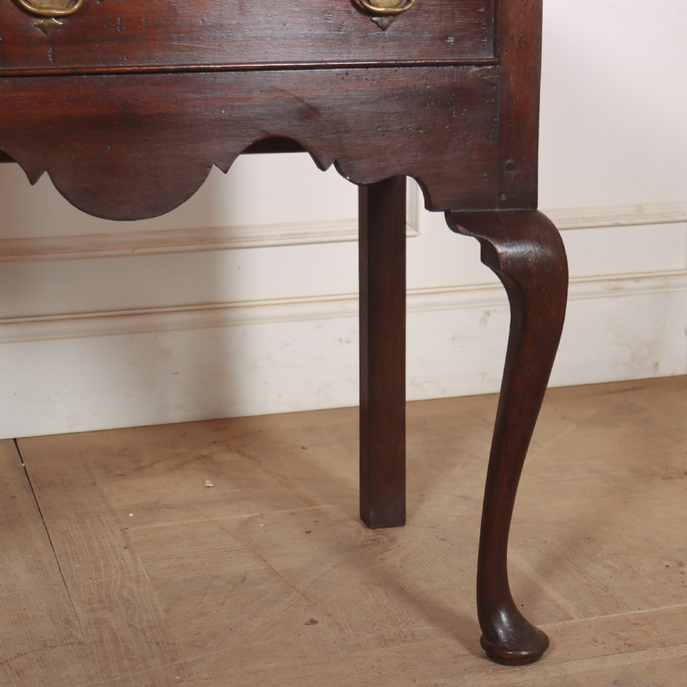 An 18th-century style dark oak dresser base featuring three frieze drawers, brass handles, a shaped apron, and elegant cabriole legs. View V
