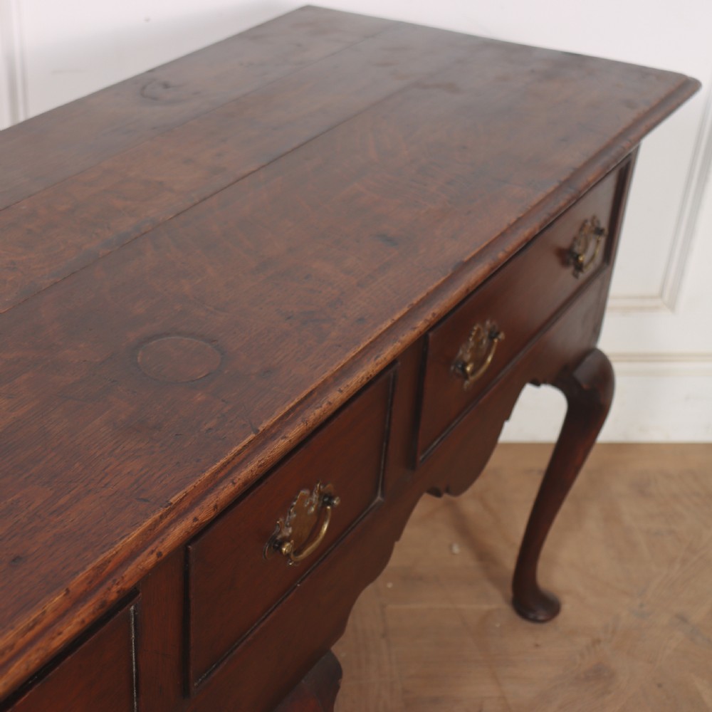 An 18th-century style dark oak dresser base featuring three frieze drawers, brass handles, a shaped apron, and elegant cabriole legs. View VIII