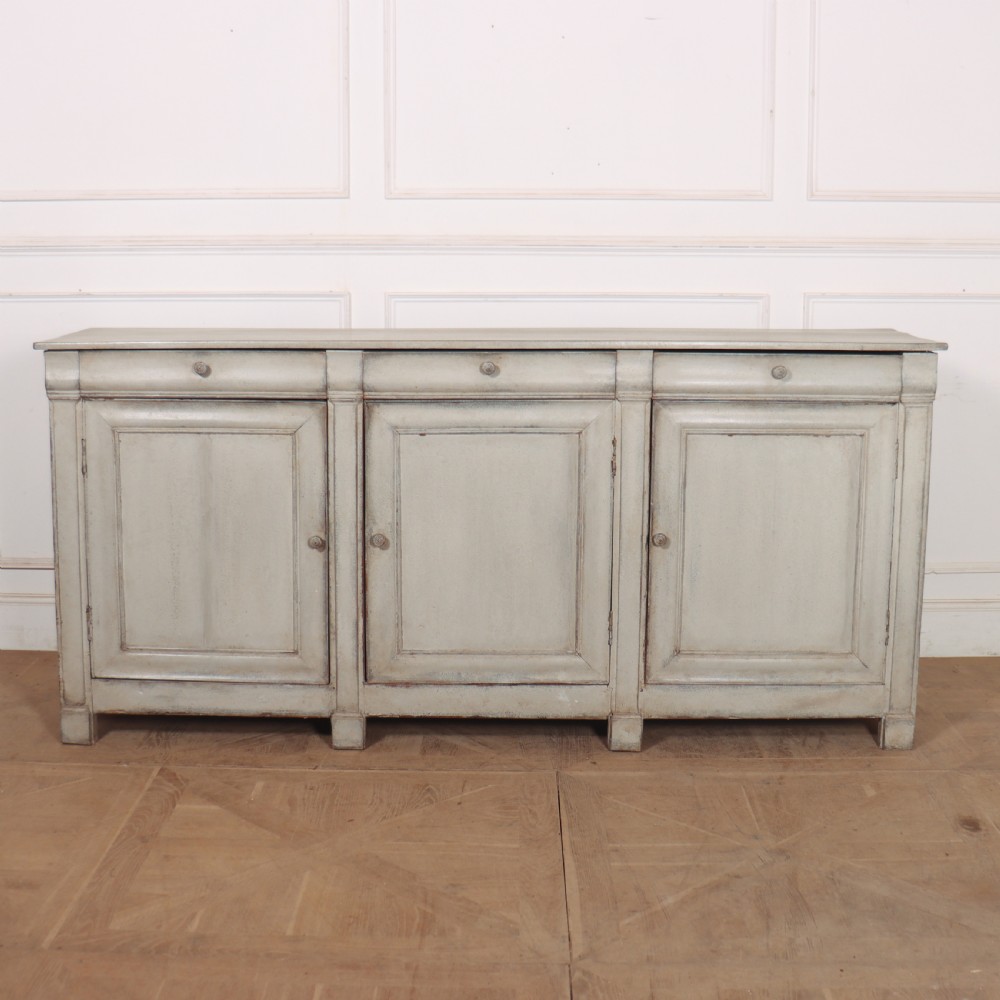 An antique French painted narrow enfilade in a distressed grey finish with three drawers over three panelled doors.