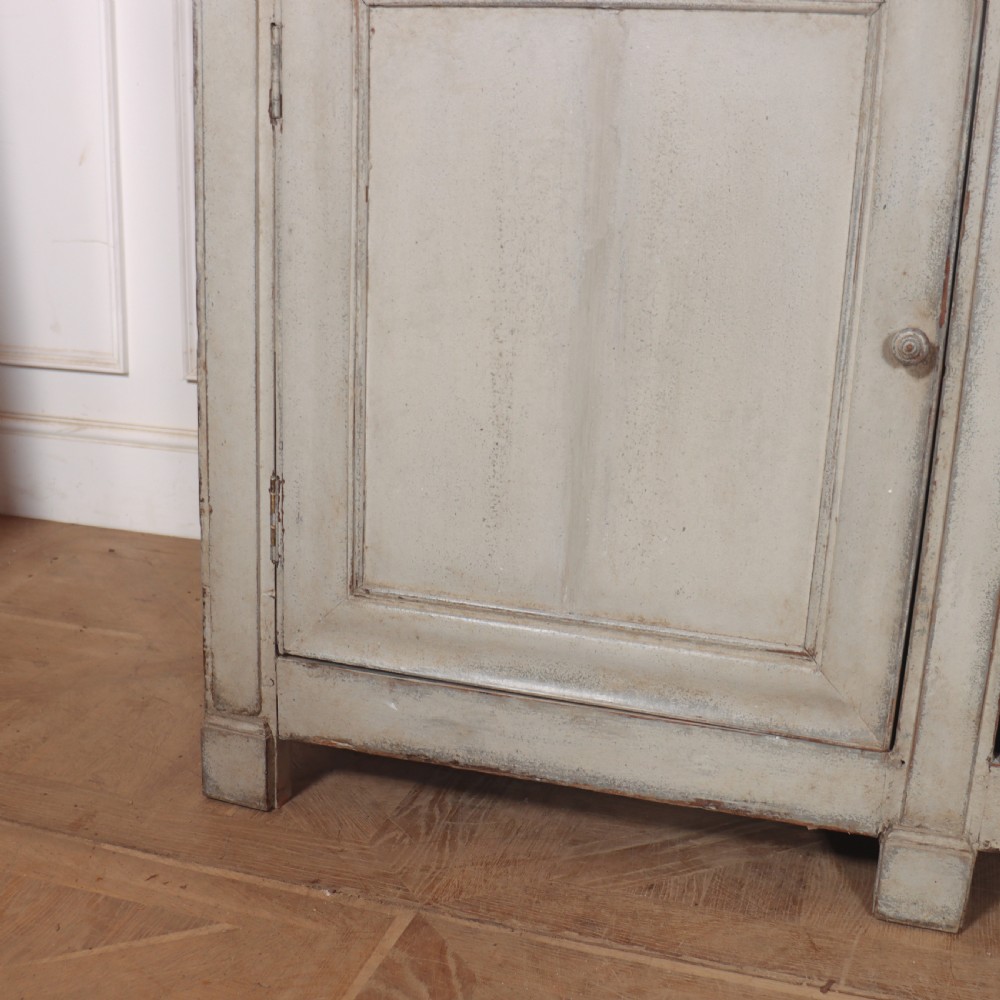 An antique French painted narrow enfilade in a distressed grey finish with three drawers over three panelled doors. View III