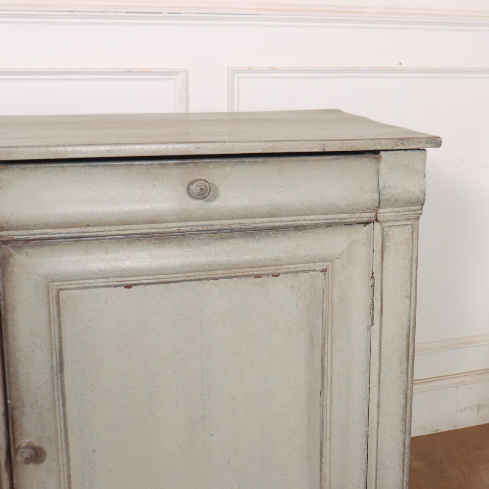 An antique French painted narrow enfilade in a distressed grey finish with three drawers over three panelled doors. View IV