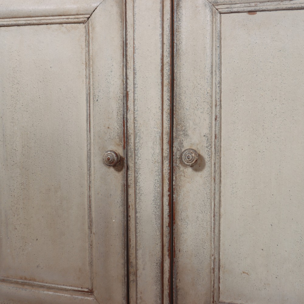An antique French painted narrow enfilade in a distressed grey finish with three drawers over three panelled doors. View VI