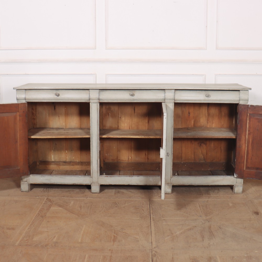An antique French painted narrow enfilade in a distressed grey finish with three drawers over three panelled doors. View VII