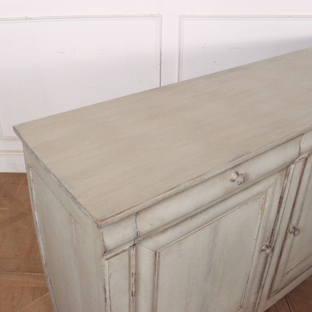 An antique French painted narrow enfilade in a distressed grey finish with three drawers over three panelled doors. View IX