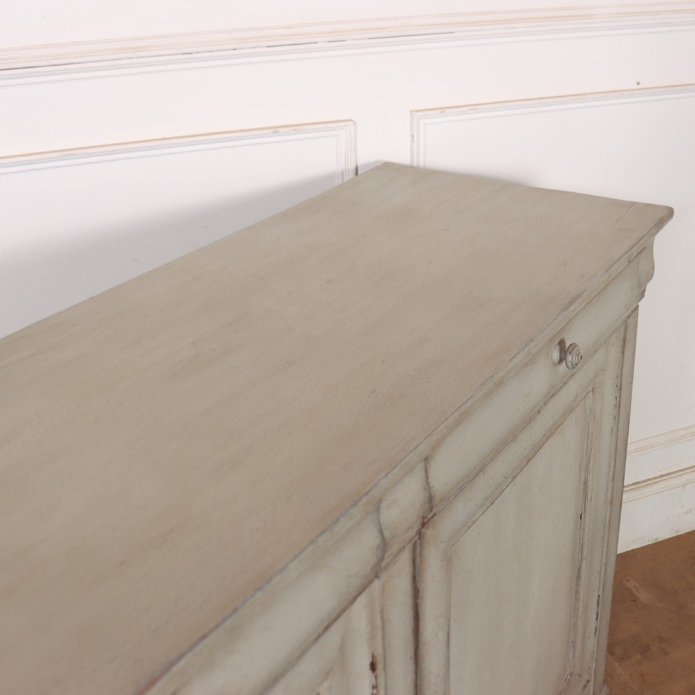 An antique French painted narrow enfilade in a distressed grey finish with three drawers over three panelled doors. View X