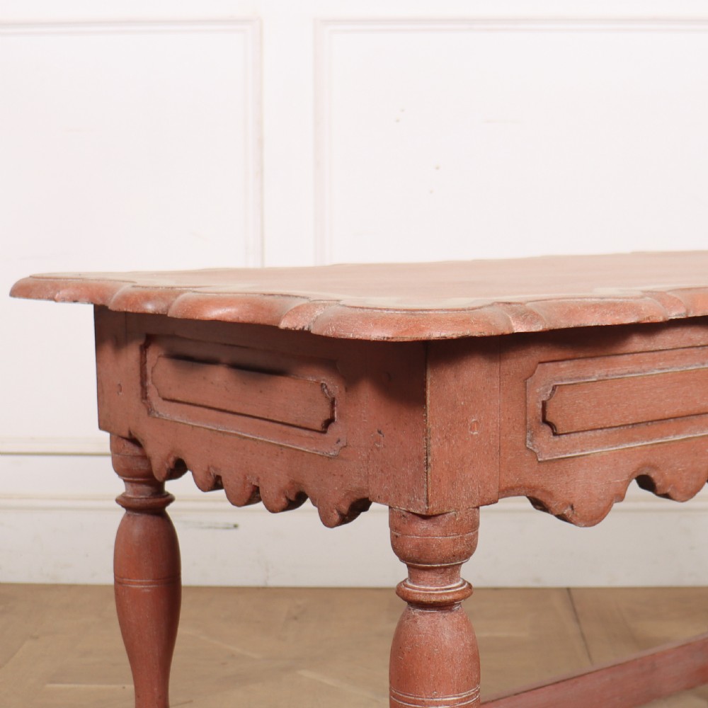 An 18th-century Dutch Baroque side table with a terracotta red painted finish, scalloped top, shaped apron, turned baluster legs, and a box stretcher. View III