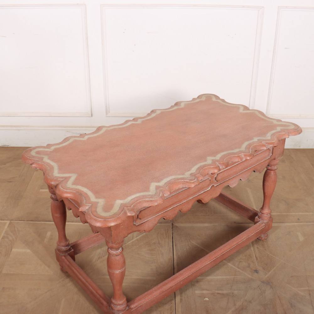 An 18th-century Dutch Baroque side table with a terracotta red painted finish, scalloped top, shaped apron, turned baluster legs, and a box stretcher. View IV