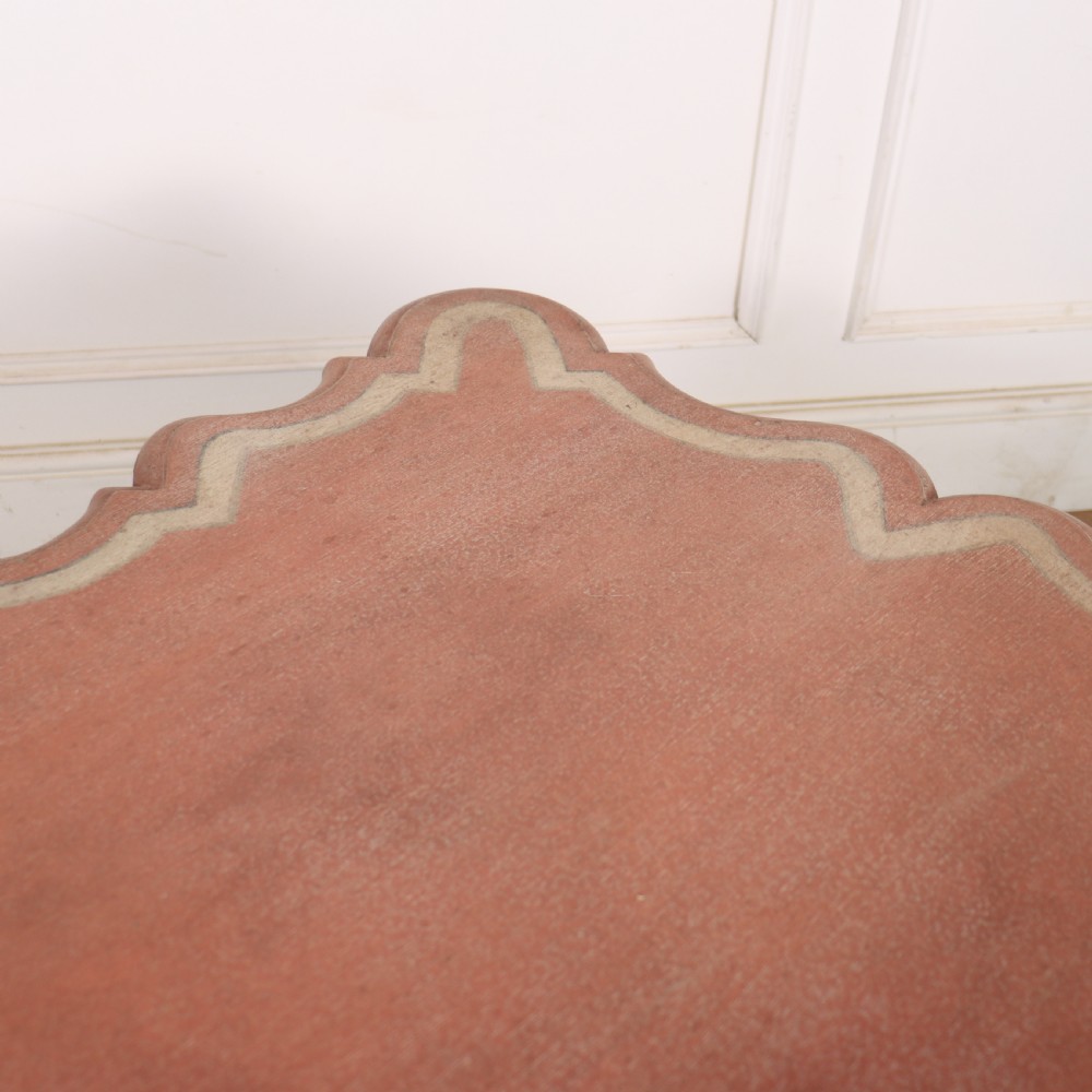 An 18th-century Dutch Baroque side table with a terracotta red painted finish, scalloped top, shaped apron, turned baluster legs, and a box stretcher. View VII