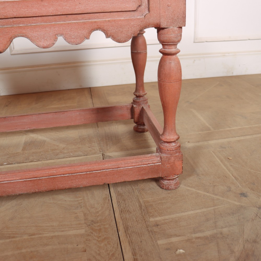 An 18th-century Dutch Baroque side table with a terracotta red painted finish, scalloped top, shaped apron, turned baluster legs, and a box stretcher. View XII