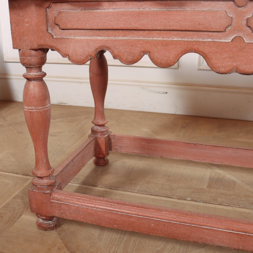 An 18th-century Dutch Baroque side table with a terracotta red painted finish, scalloped top, shaped apron, turned baluster legs, and a box stretcher. View XIII