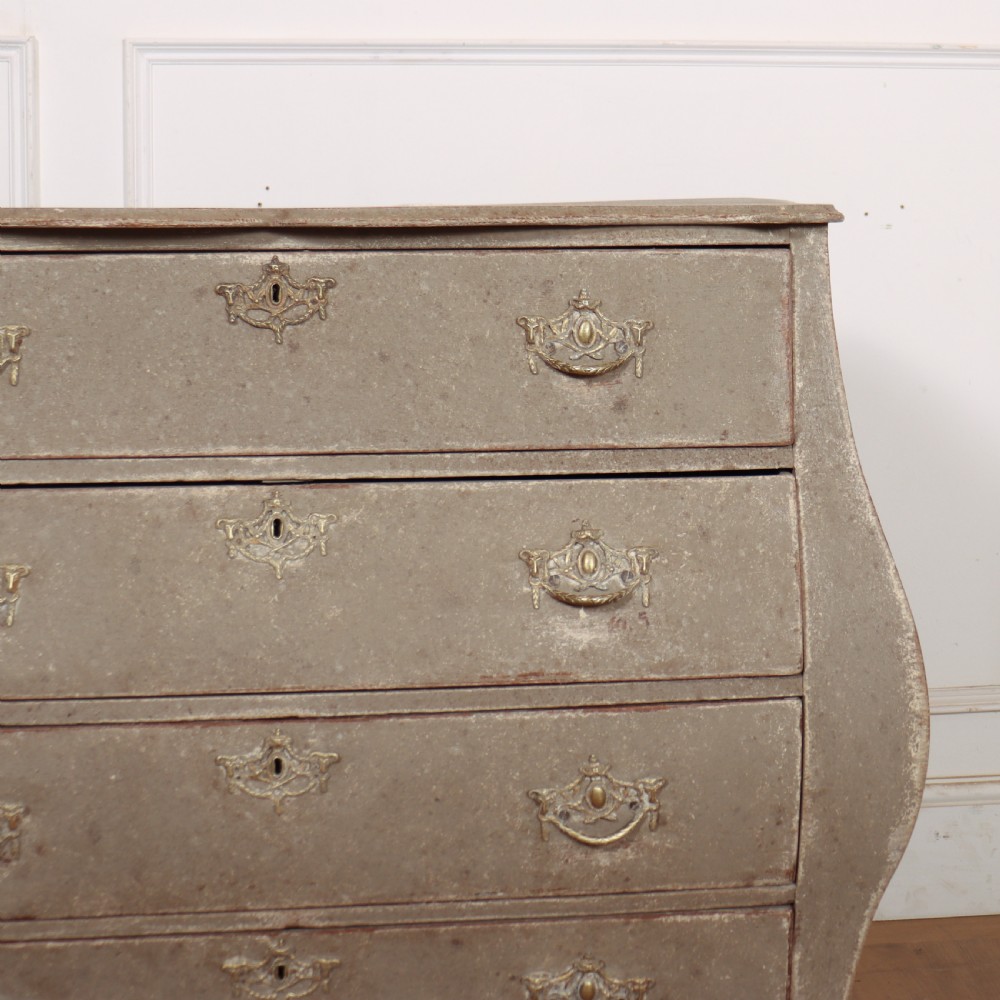 A 19th-century Dutch bombe commode featuring a distressed grey painted finish, four drawers, and decorative brass hardware. View III