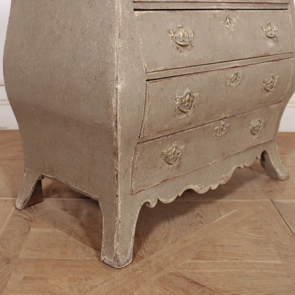 A 19th-century Dutch bombe commode featuring a distressed grey painted finish, four drawers, and decorative brass hardware. View VIII