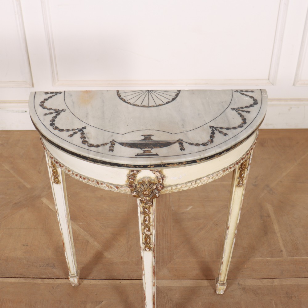 A French Louis XVI style cream painted and gilded demi-lune console table with tapered legs. View V