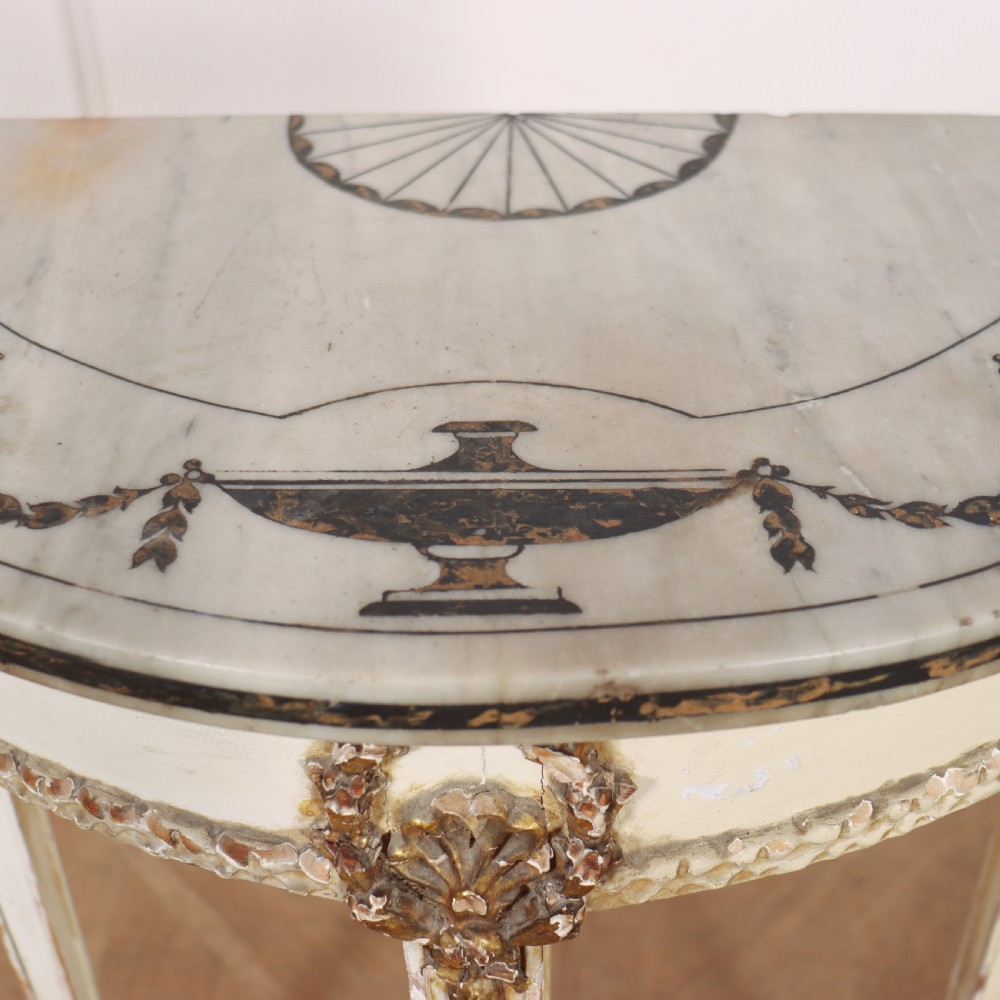 A French Louis XVI style cream painted and gilded demi-lune console table with tapered legs. View VIII