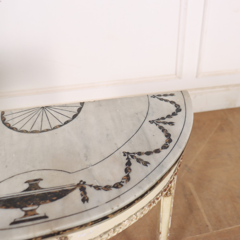 A French Louis XVI style cream painted and gilded demi-lune console table with tapered legs. View IX