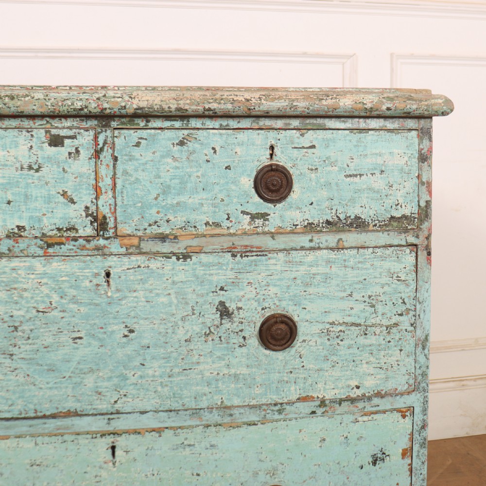 An English chest of drawers with distressed pale blue original paint, featuring two short drawers over two long drawers and turned dark wooden handles. View II
