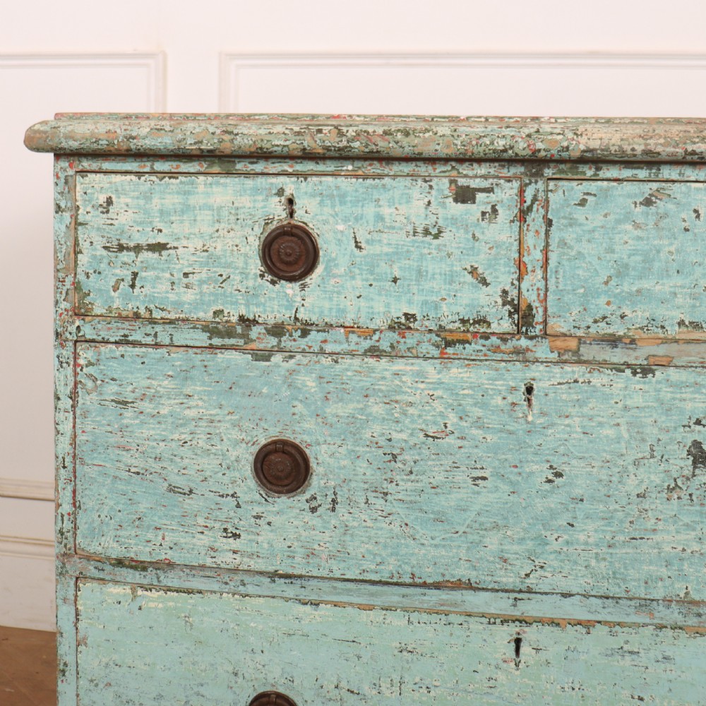 An English chest of drawers with distressed pale blue original paint, featuring two short drawers over two long drawers and turned dark wooden handles. View III