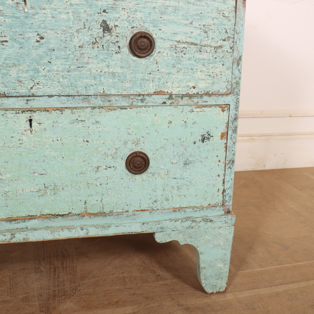An English chest of drawers with distressed pale blue original paint, featuring two short drawers over two long drawers and turned dark wooden handles. View IV