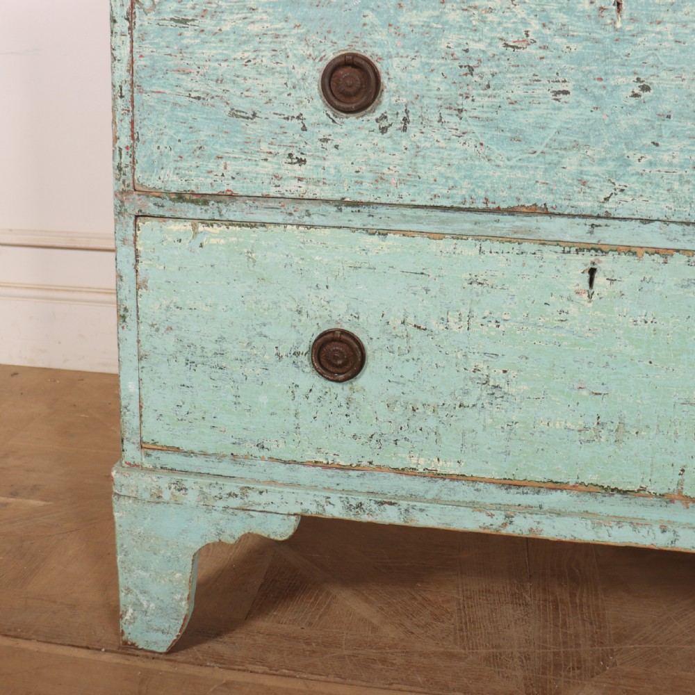 An English chest of drawers with distressed pale blue original paint, featuring two short drawers over two long drawers and turned dark wooden handles. View V
