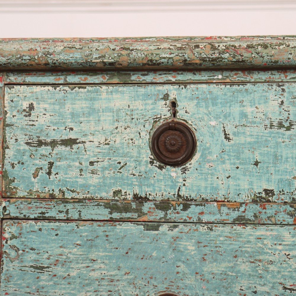 An English chest of drawers with distressed pale blue original paint, featuring two short drawers over two long drawers and turned dark wooden handles. View VI