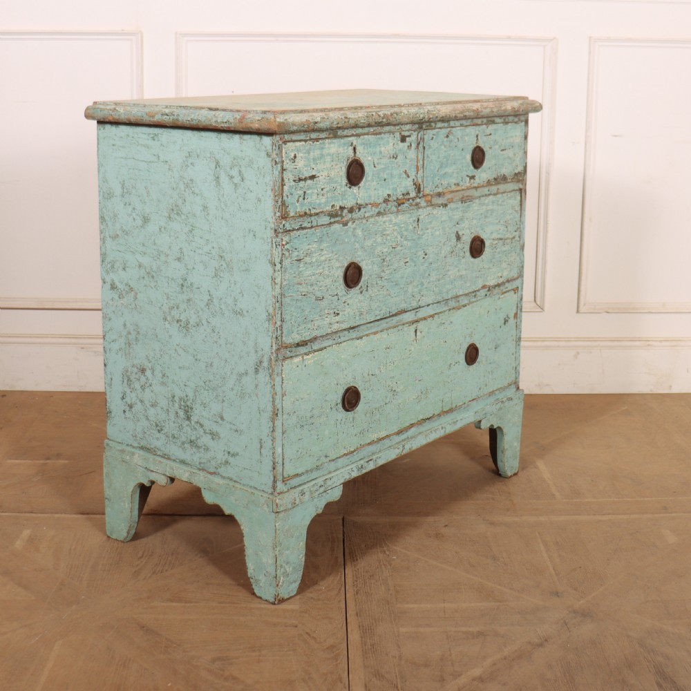 An English chest of drawers with distressed pale blue original paint, featuring two short drawers over two long drawers and turned dark wooden handles. View VII