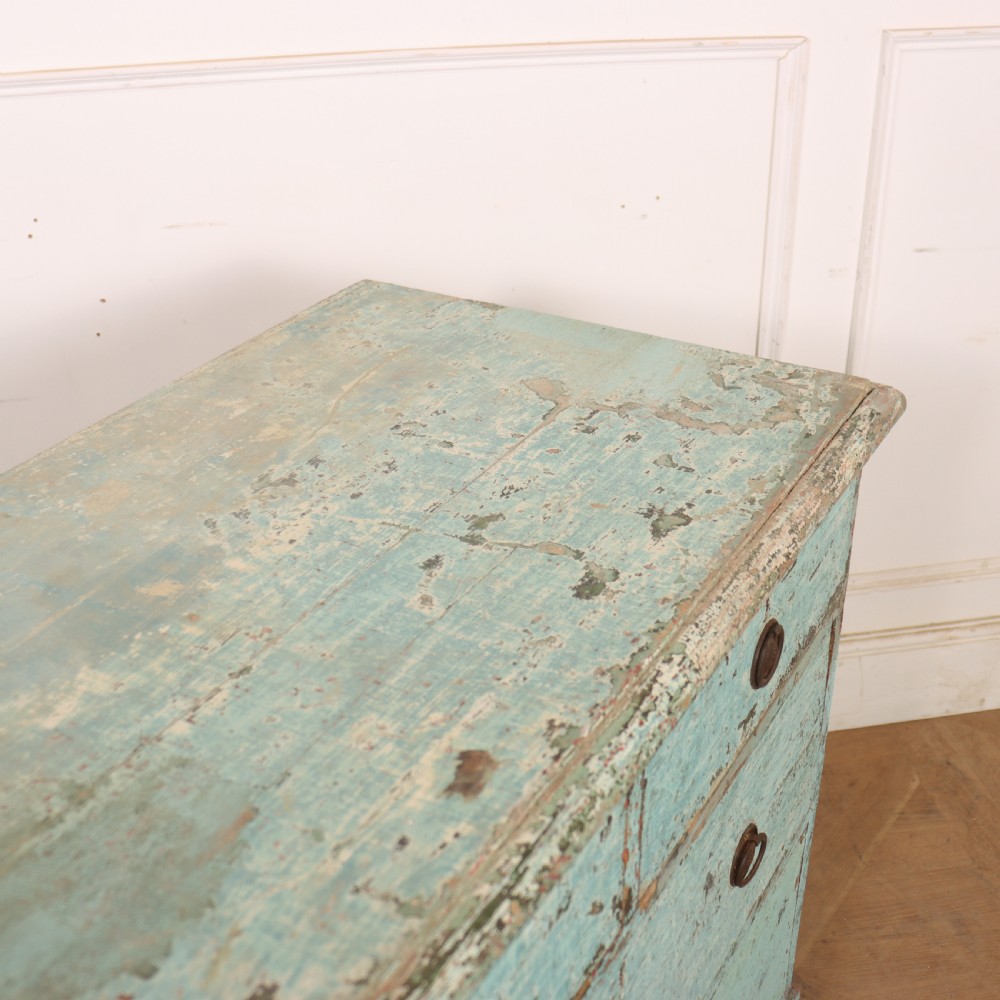 An English chest of drawers with distressed pale blue original paint, featuring two short drawers over two long drawers and turned dark wooden handles. View VIII