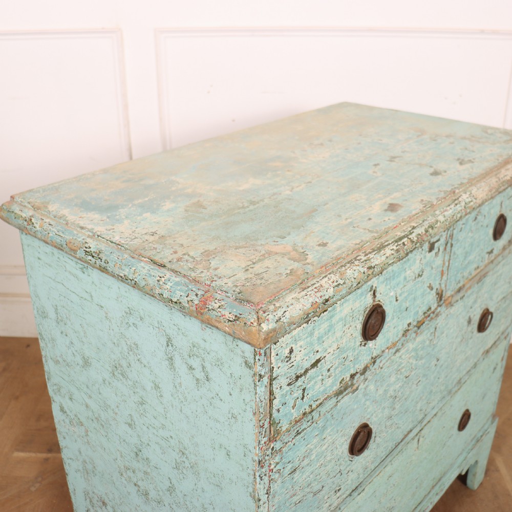An English chest of drawers with distressed pale blue original paint, featuring two short drawers over two long drawers and turned dark wooden handles. View IX