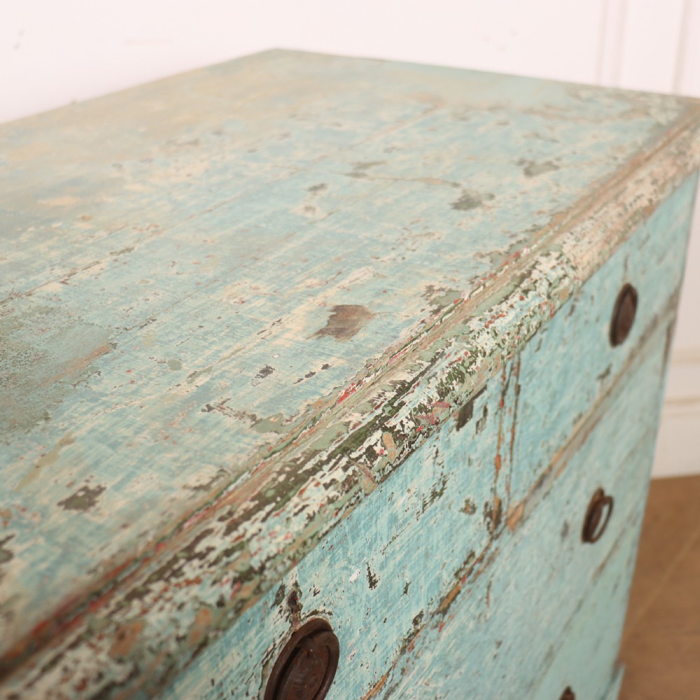 An English chest of drawers with distressed pale blue original paint, featuring two short drawers over two long drawers and turned dark wooden handles. View X