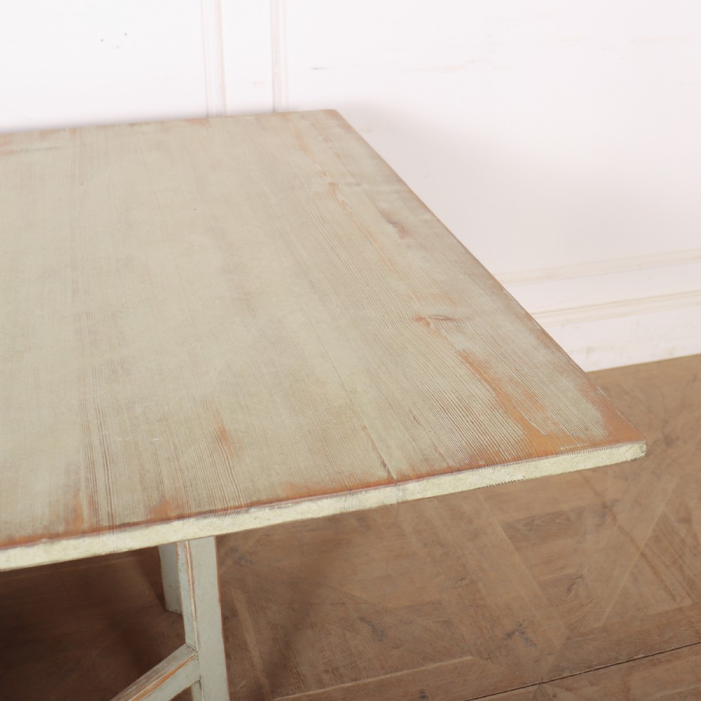 A folded Swedish slagbord drop-leaf dining table with distressed pale green paint over pine timber. View VI