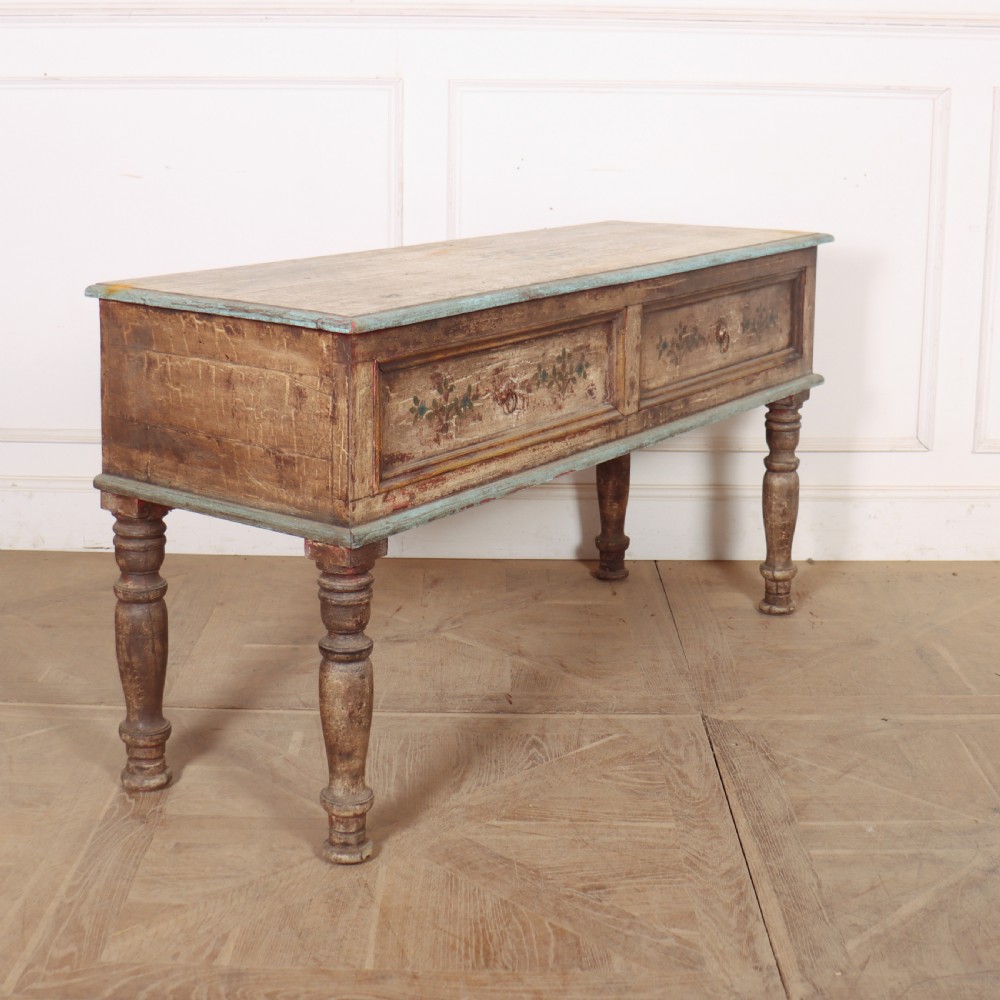 A long colonial painted wooden serving table featuring two drawers decorated with hand-painted floral motifs, brass ring handles, and four turned legs. View VII