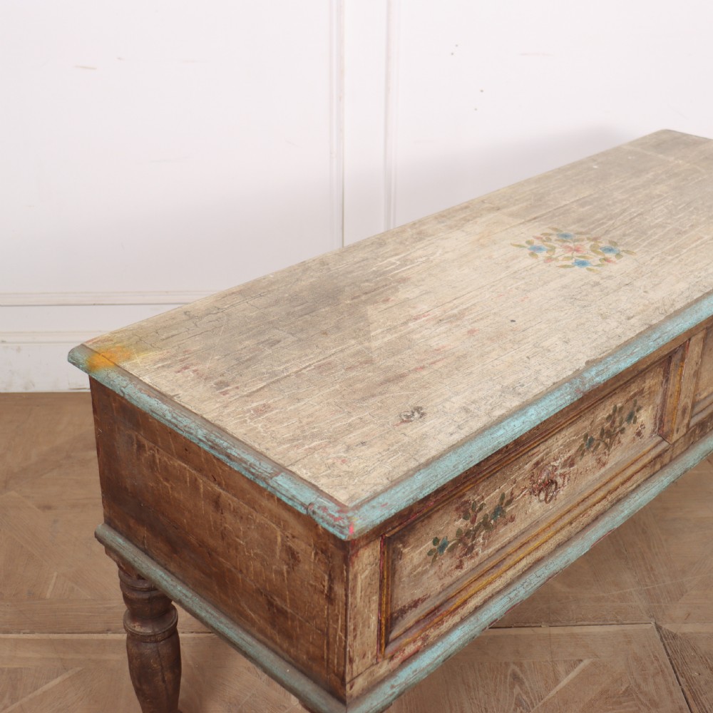 A long colonial painted wooden serving table featuring two drawers decorated with hand-painted floral motifs, brass ring handles, and four turned legs. View VIII