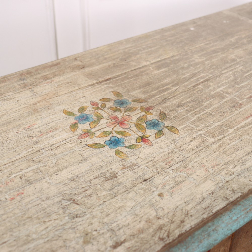 A long colonial painted wooden serving table featuring two drawers decorated with hand-painted floral motifs, brass ring handles, and four turned legs. View X