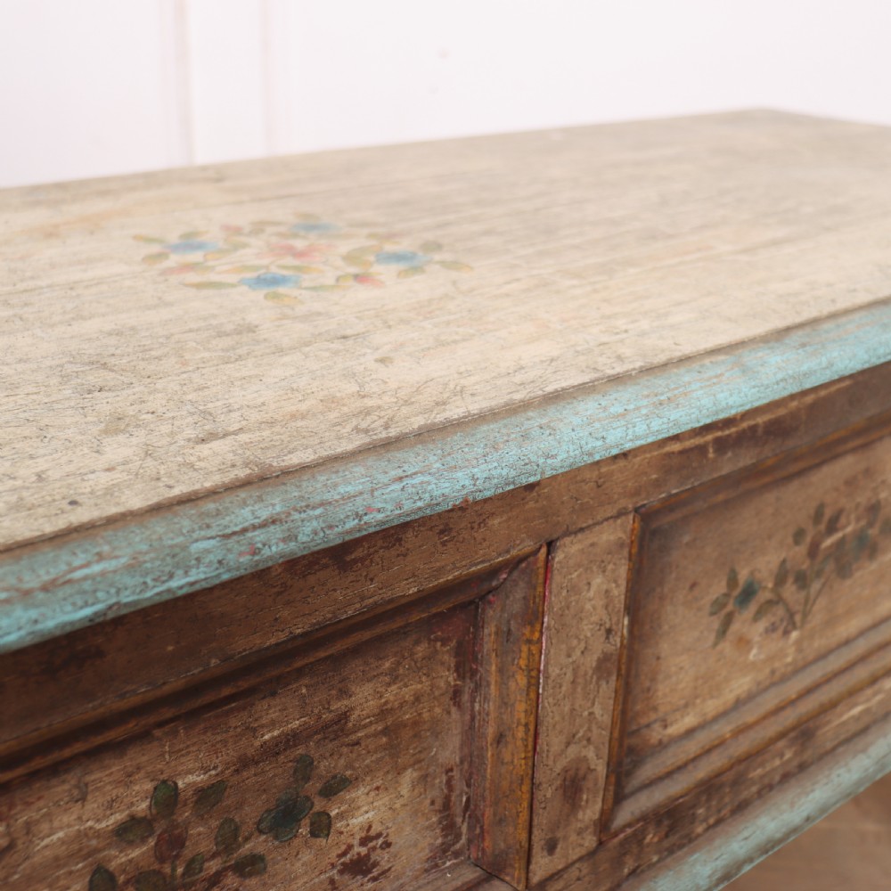 A long colonial painted wooden serving table featuring two drawers decorated with hand-painted floral motifs, brass ring handles, and four turned legs. View XI