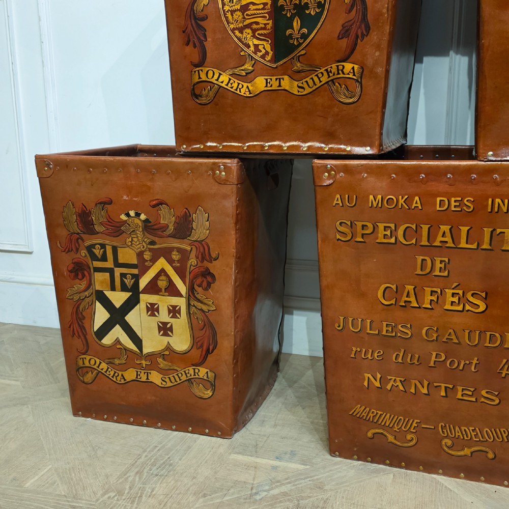 A collection of warm brown studded leather storage bins decorated with gilded French typography and heraldic crests. View XI