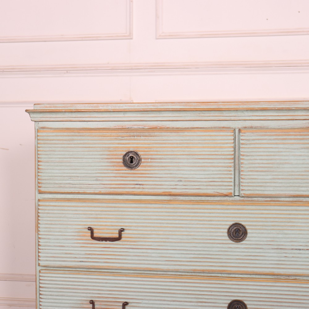 A Swedish painted pine commode featuring horizontal fluted drawer fronts, a pale blue distressed finish, and iron hardware. View II