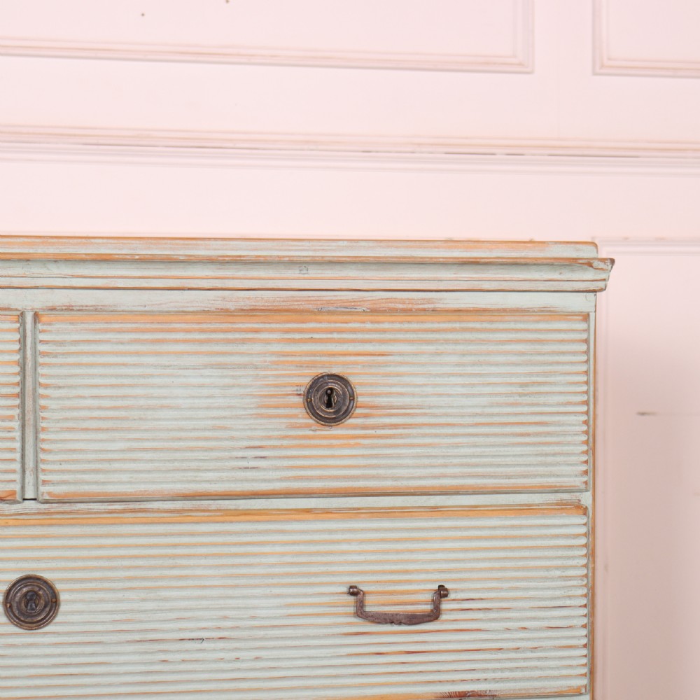 A Swedish painted pine commode featuring horizontal fluted drawer fronts, a pale blue distressed finish, and iron hardware. View III