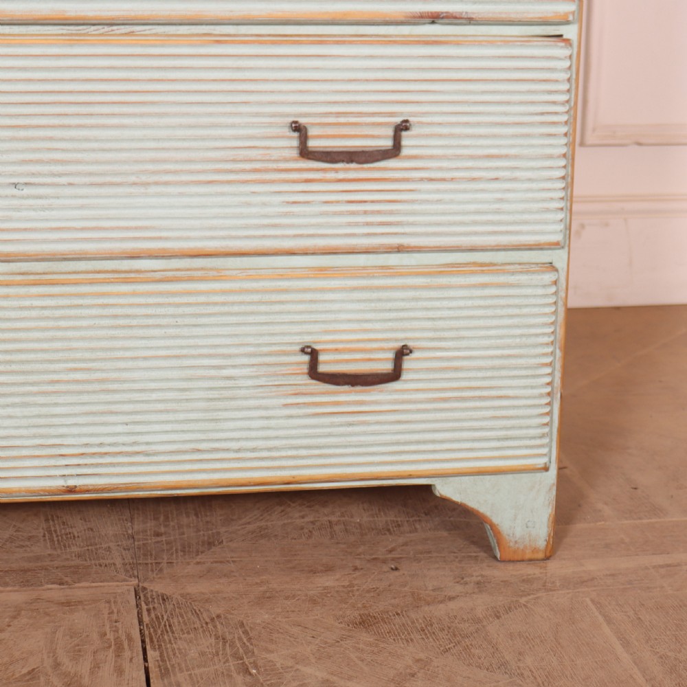 A Swedish painted pine commode featuring horizontal fluted drawer fronts, a pale blue distressed finish, and iron hardware. View IV