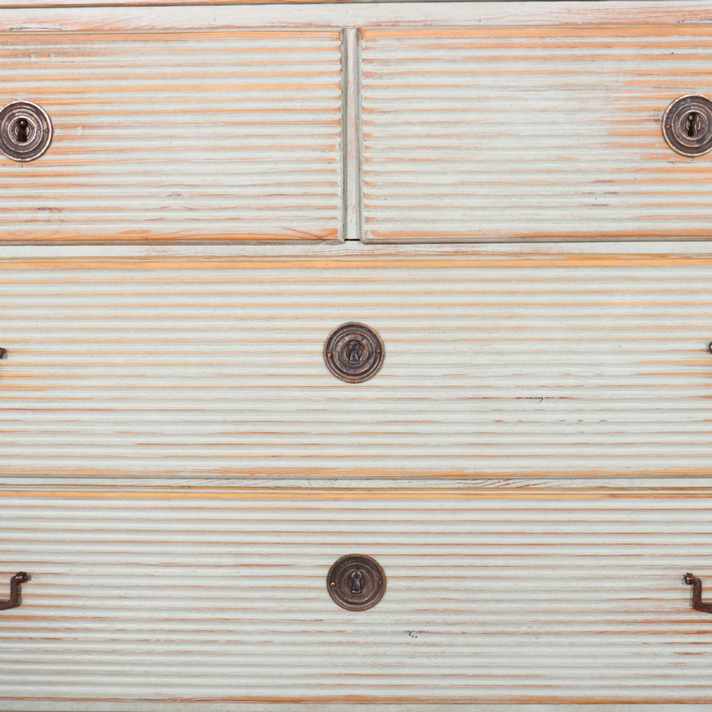 A Swedish painted pine commode featuring horizontal fluted drawer fronts, a pale blue distressed finish, and iron hardware. View VI