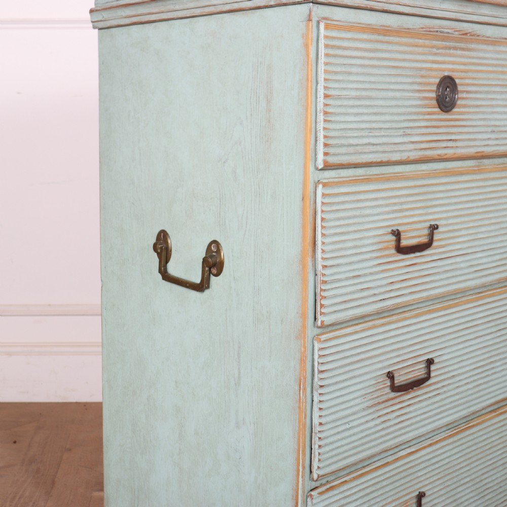 A Swedish painted pine commode featuring horizontal fluted drawer fronts, a pale blue distressed finish, and iron hardware. View VIII
